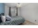 Cozy bedroom featuring a patterned bedspread, tile floors, and a ceiling fan at 3021 E Larkspur Dr, Phoenix, AZ 85032