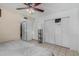 Bedroom with tiled flooring, a ceiling fan, and spacious closets at 3021 E Larkspur Dr, Phoenix, AZ 85032