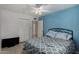 Comfortable bedroom featuring a patterned bedspread, blue accent wall, and tile floors at 3021 E Larkspur Dr, Phoenix, AZ 85032