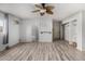 Spacious bedroom featuring wood-style floors, ceiling fan, and access to the bathroom at 3021 E Larkspur Dr, Phoenix, AZ 85032