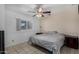 Clean bedroom featuring tiled flooring, a ceiling fan, and natural lighting at 3021 E Larkspur Dr, Phoenix, AZ 85032