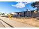 Single story grey home with front lawn and walkway to front door at 3021 E Larkspur Dr, Phoenix, AZ 85032