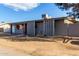 Single story grey home with front lawn and walkway to front door at 3021 E Larkspur Dr, Phoenix, AZ 85032