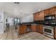 Functional kitchen featuring tile floors, wooden cabinets, and stainless steel appliances at 3021 E Larkspur Dr, Phoenix, AZ 85032