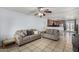 Open concept living room with tile floors connecting to kitchen space at 3021 E Larkspur Dr, Phoenix, AZ 85032