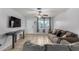 Inviting living room with a comfy couch, tile floors, and natural light from the windows at 3021 E Larkspur Dr, Phoenix, AZ 85032