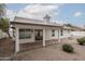Covered patio with tiled floor overlooking the xeriscaped backyard and desert landscaping at 3022 E Emile Zola Ave, Phoenix, AZ 85032