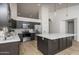 A beautifully renovated kitchen with stainless steel appliances, dark cabinets and a spacious white marble island at 3022 E Emile Zola Ave, Phoenix, AZ 85032