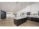 Open floor plan showcasing a modern kitchen with an island, dark cabinets, and stainless steel appliances at 3022 E Emile Zola Ave, Phoenix, AZ 85032