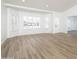 Bright living room showcasing a large bay window, plantation shutters, and sleek light colored flooring at 3022 E Emile Zola Ave, Phoenix, AZ 85032