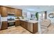 Open concept kitchen with stainless steel appliances, stylish cabinets, and a view into the living room at 3141 S 155Th Ln, Goodyear, AZ 85338