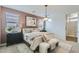 Well-lit main bedroom with neutral tones, chic lighting, and plush bedding for a restful and stylish retreat at 3141 S 155Th Ln, Goodyear, AZ 85338
