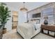 Cozy bedroom with a brick accent wall, stylish lighting fixture, and a large walk-in closet at 3141 S 155Th Ln, Goodyear, AZ 85338