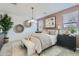 Bright main bedroom featuring elegant decor, neutral walls, contemporary lighting, and large windows with natural light at 3141 S 155Th Ln, Goodyear, AZ 85338