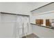 Clean walk-in closet with white walls, sturdy shelves, and two white robes hanging from the railing at 3141 S 155Th Ln, Goodyear, AZ 85338