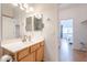 This bathroom offers a well-lit vanity area and a view into an adjacent bedroom at 3252 E Maldonado Dr, Phoenix, AZ 85042