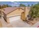 Inviting tan home with a two-car garage, a well-maintained yard, and a tile roof at 3252 E Maldonado Dr, Phoenix, AZ 85042
