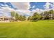 Green space with walking path, mature trees, and desert landscaping in a golf community at 3252 E Maldonado Dr, Phoenix, AZ 85042