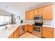 Modern kitchen featuring stainless steel appliances, countertops, and ample cabinet space at 3252 E Maldonado Dr, Phoenix, AZ 85042