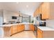 Spacious kitchen featuring stainless steel appliances and light wood floors at 3252 E Maldonado Dr, Phoenix, AZ 85042