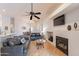 Open-concept living room with hardwood floors, a fireplace, and plenty of natural light at 3252 E Maldonado Dr, Phoenix, AZ 85042