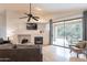 A stylish living room with a fireplace, hardwood floors, and a sliding glass door to a patio at 3252 E Maldonado Dr, Phoenix, AZ 85042