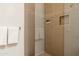 Walk-in shower featuring tiled walls with built-in shelf and modern fixtures at 3252 E Maldonado Dr, Phoenix, AZ 85042