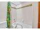 Fresh bathroom featuring a clean bathtub, bright shower curtain, and tiled walls at 3637 E Monterosa St # 3, Phoenix, AZ 85018