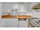 Functional kitchen features wood countertops, white cabinets, and a stainless steel sink at 3637 E Monterosa St # 3, Phoenix, AZ 85018