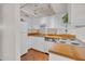 Well-lit kitchen boasts white cabinets, wooden countertops, and sleek, modern appliances at 3637 E Monterosa St # 3, Phoenix, AZ 85018