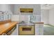 A well-equipped kitchen features white cabinets, wood countertops, and modern cooking appliances at 3637 E Monterosa St # 3, Phoenix, AZ 85018