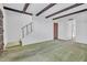 Open-concept living space features a staircase, exposed beams, and access to other areas of the home at 3637 E Monterosa St # 3, Phoenix, AZ 85018