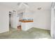 Bright living space featuring kitchen, neutral walls, and soft green carpeting at 3637 E Monterosa St # 3, Phoenix, AZ 85018