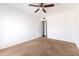 An empty bedroom featuring neutral walls, carpet, and a ceiling fan, ready for personal touches at 4133 E Pleasant Ln, Phoenix, AZ 85042