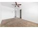 A spacious bedroom features a ceiling fan, a closet and a window that provides plenty of natural light at 4133 E Pleasant Ln, Phoenix, AZ 85042