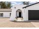 The home's entryway is marked by an archway and accented by a black-trimmed garage at 4133 E Pleasant Ln, Phoenix, AZ 85042