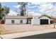 Charming single-story home featuring a crisp white exterior, complemented by a two-car garage and a low maintenance yard at 4133 E Pleasant Ln, Phoenix, AZ 85042