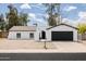 Charming single-story home featuring a crisp white exterior, complemented by a two-car garage and a low maintenance yard at 4133 E Pleasant Ln, Phoenix, AZ 85042