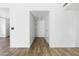 Hallway featuring wood floors, white walls, and neutral colored doors leading to other rooms in the home at 4133 E Pleasant Ln, Phoenix, AZ 85042