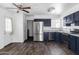 Bright kitchen featuring stainless steel appliances, dark wood cabinets, and a door leading to the backyard at 4133 E Pleasant Ln, Phoenix, AZ 85042