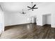 Open living room with high ceilings, sliding doors, and wood floors offer a light filled space at 4133 E Pleasant Ln, Phoenix, AZ 85042