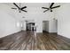 Spacious living room features modern ceiling fans and a view into the kitchen, showcasing an open layout at 4133 E Pleasant Ln, Phoenix, AZ 85042