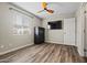 Comfortable bedroom with wood-look floors, a ceiling fan, and natural light from a window at 5127 W Willow Ave, Glendale, AZ 85304