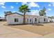 Charming single-story home with desert landscaping, white stucco, arched porch and mature palm tree at 5127 W Willow Ave, Glendale, AZ 85304