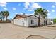 Charming single-story home featuring a stucco exterior, brown roof, and well-maintained landscaping with mature palm trees at 5127 W Willow Ave, Glendale, AZ 85304