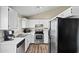 Well-lit kitchen with stainless steel appliances, white cabinets and wood-look flooring at 5127 W Willow Ave, Glendale, AZ 85304