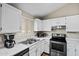 Bright kitchen with white cabinets, white countertop and modern stainless steel appliances at 5127 W Willow Ave, Glendale, AZ 85304