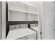 Well-organized laundry area featuring a washer, dryer, and ample shelving for storage needs at 5127 W Willow Ave, Glendale, AZ 85304