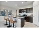 Modern kitchen featuring a granite island with seating and stainless steel appliances at 5751 E Axle Ln, San Tan Valley, AZ 85140