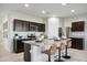 Contemporary kitchen boasts an island with bar stools and stainless steel appliances at 5751 E Axle Ln, San Tan Valley, AZ 85140